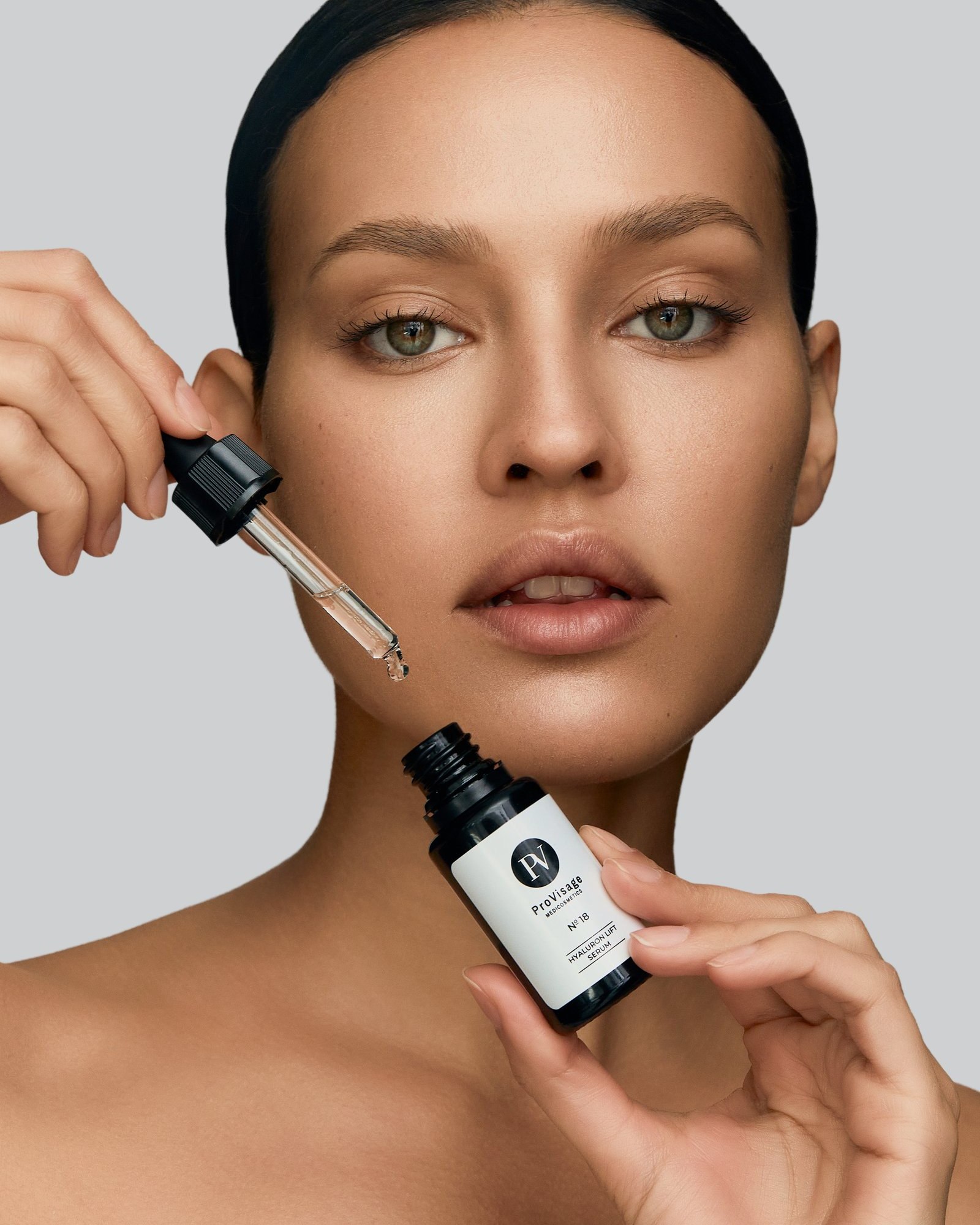 Skincare serum application, close-up portrait