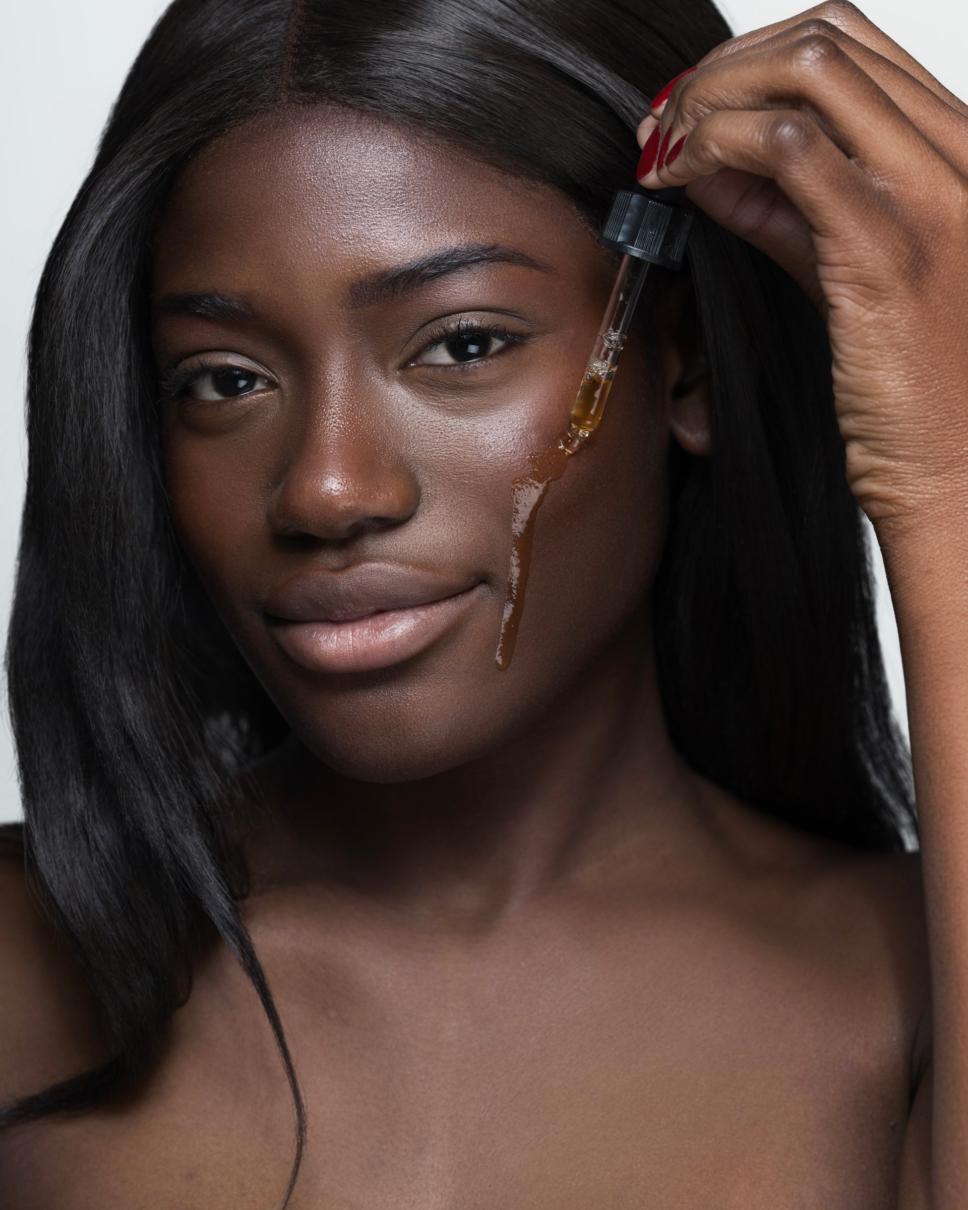Skincare oil application, close-up portrait