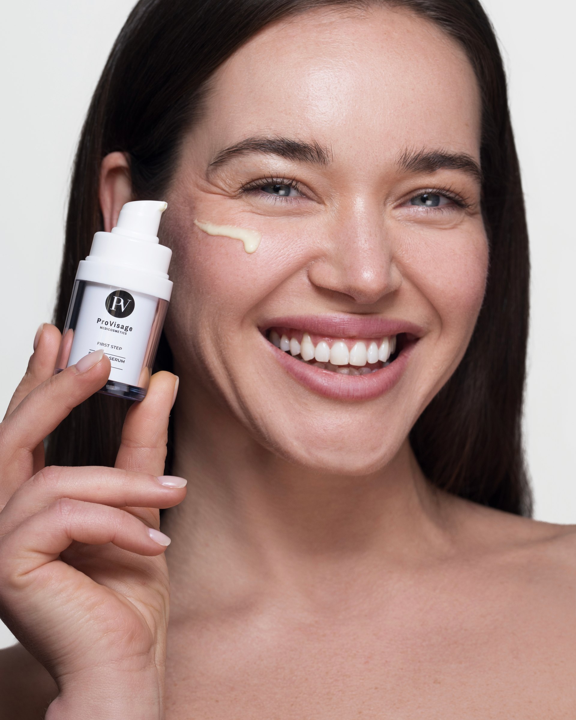 Skincare product, applying cream to cheek