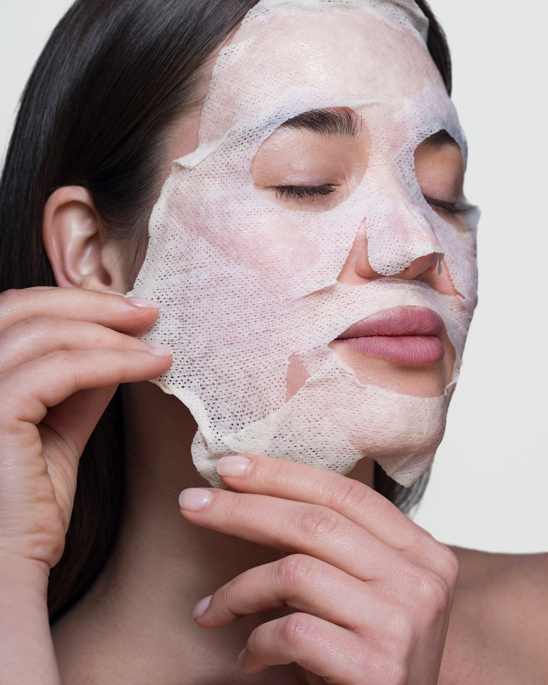 Sheet mask application, close-up portrait