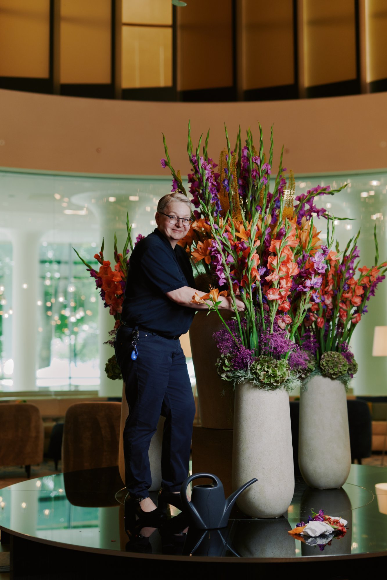 Florist arranging a large floral display, hotel lobby