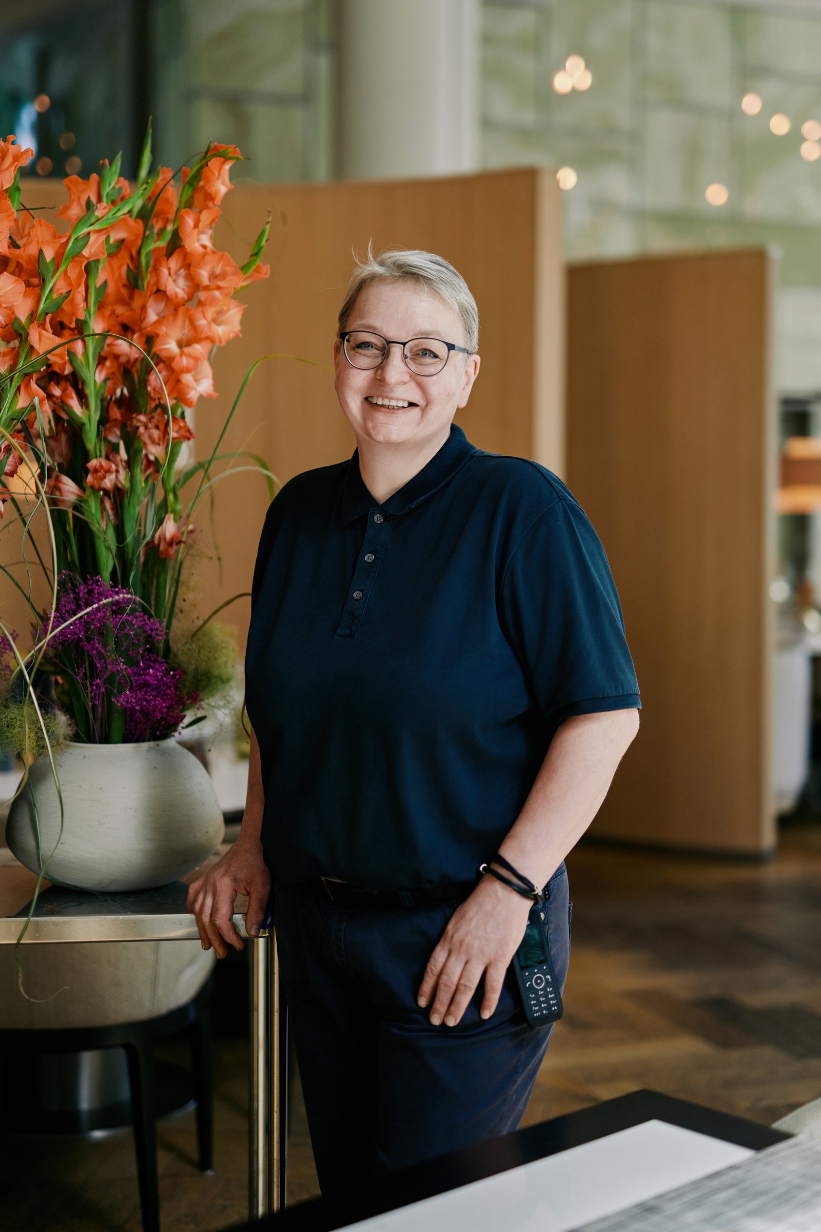 Florist portrait beside a gladiolus arrangement