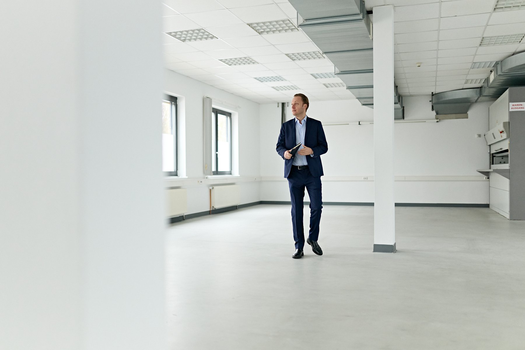 Office portrait, standing in an empty interior