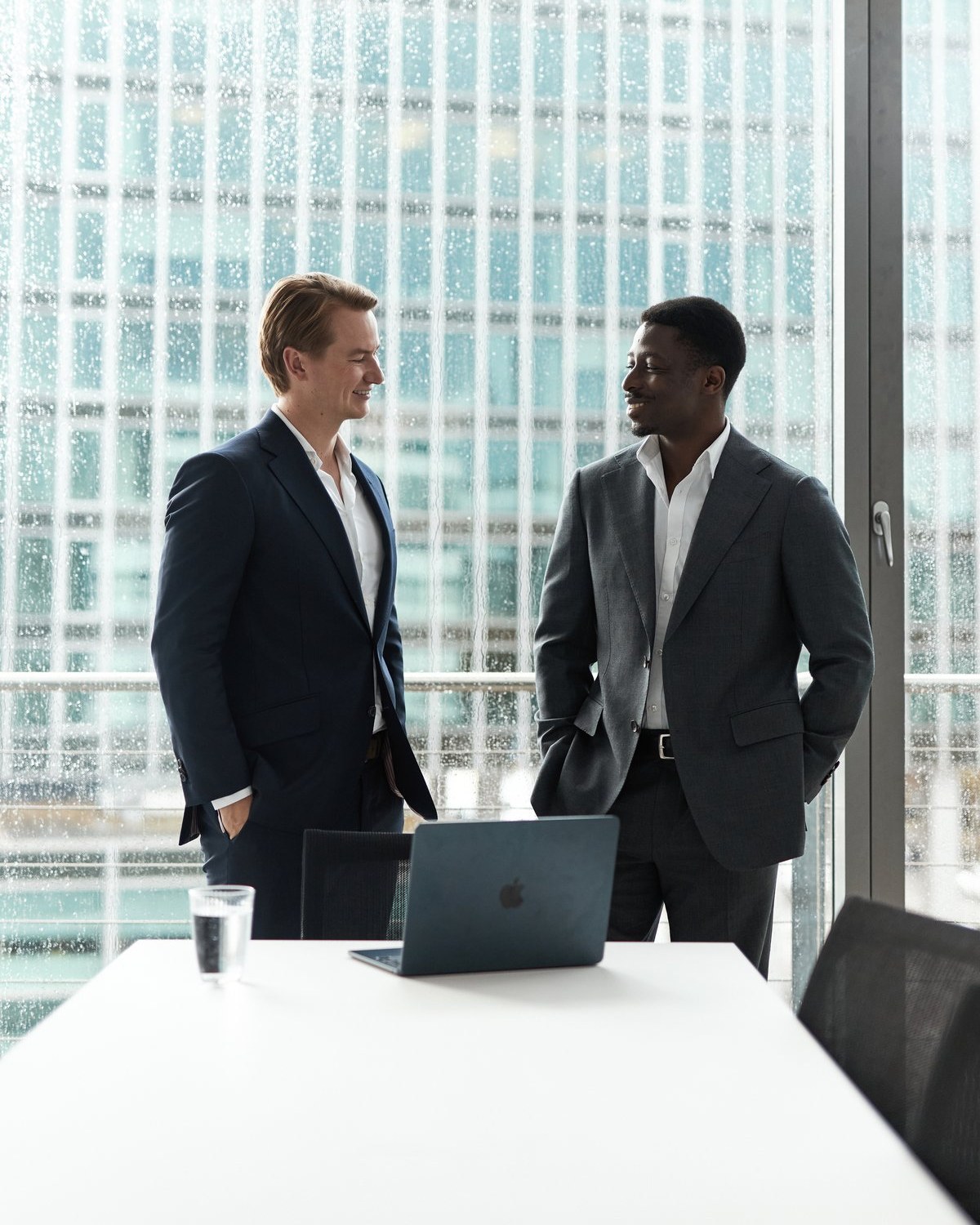 Colleagues talking by a window