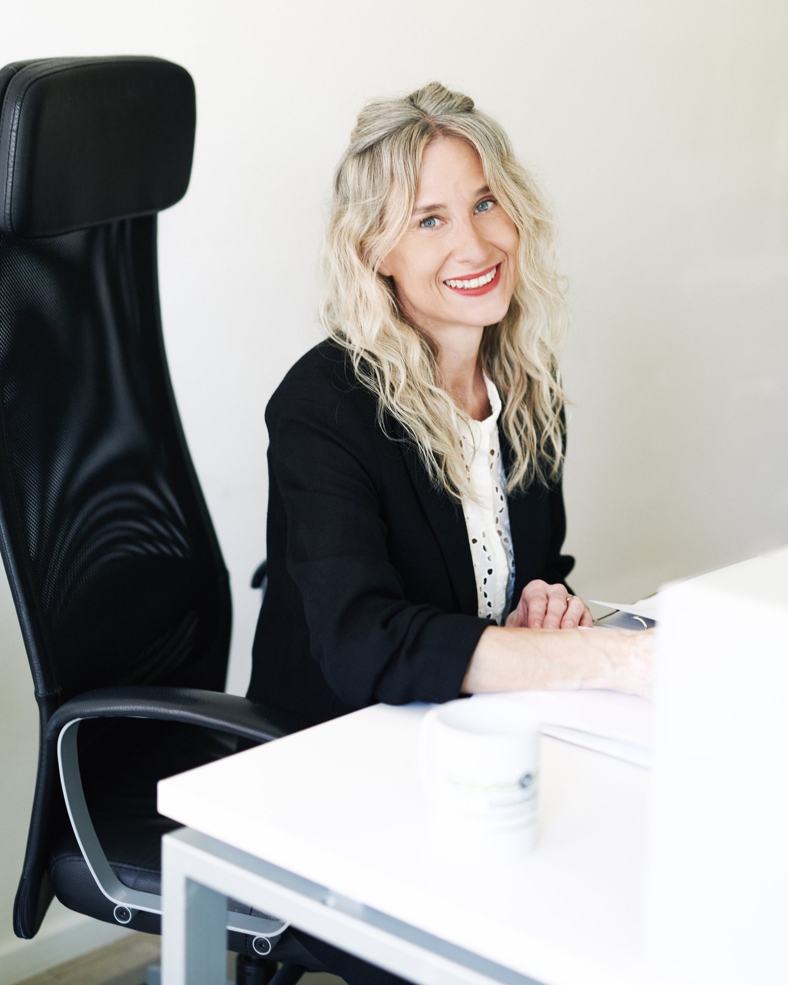 Office portrait, seated at desk with coffee