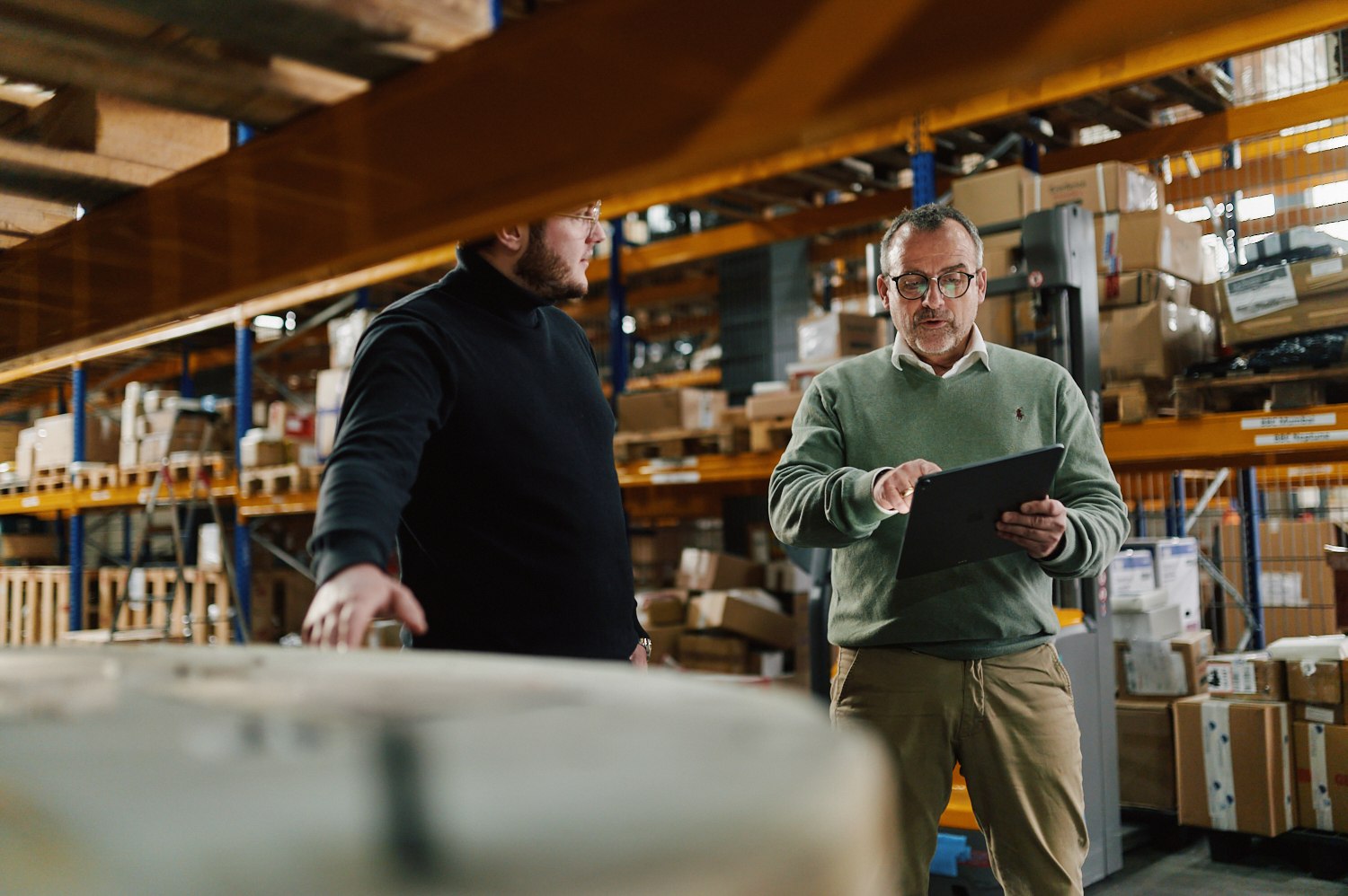 Warehouse team, reviewing inventory on a tablet