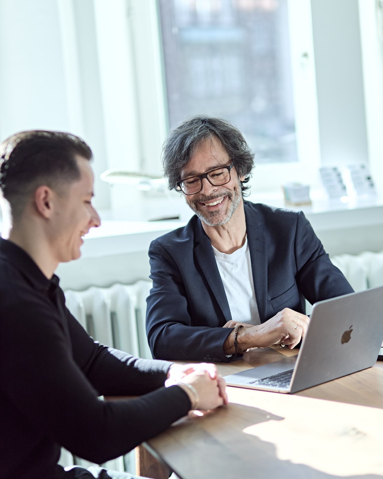Colleagues reviewing work, laptop
