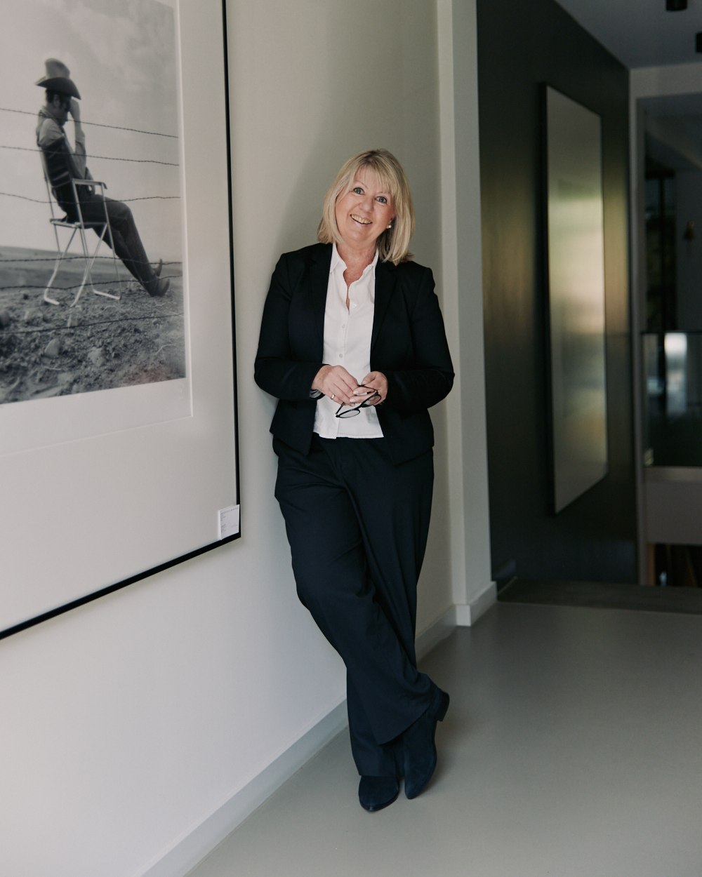 Office portrait, by a framed photograph