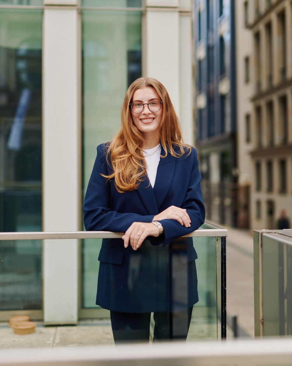 Office portrait, leaning on a railing