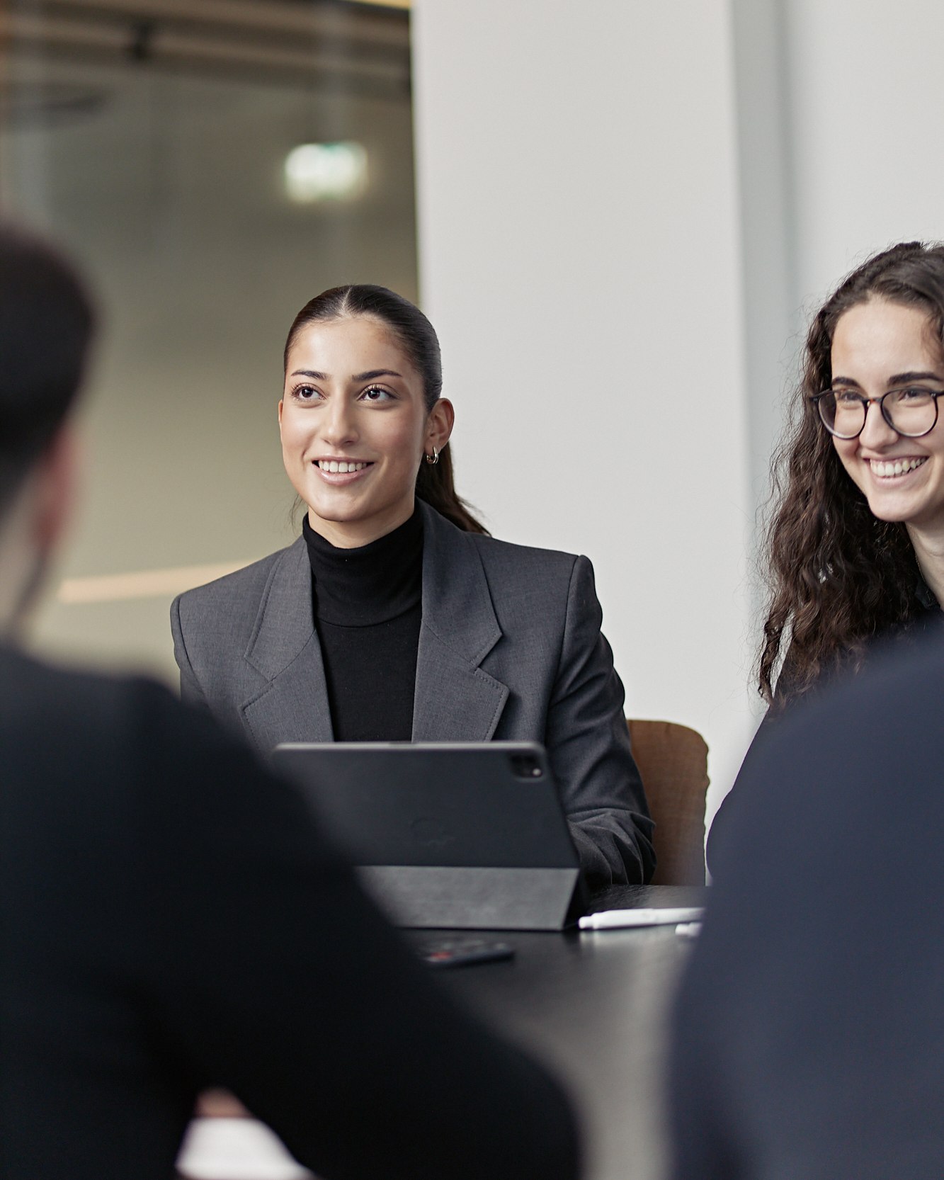 Team meeting, colleagues smiling