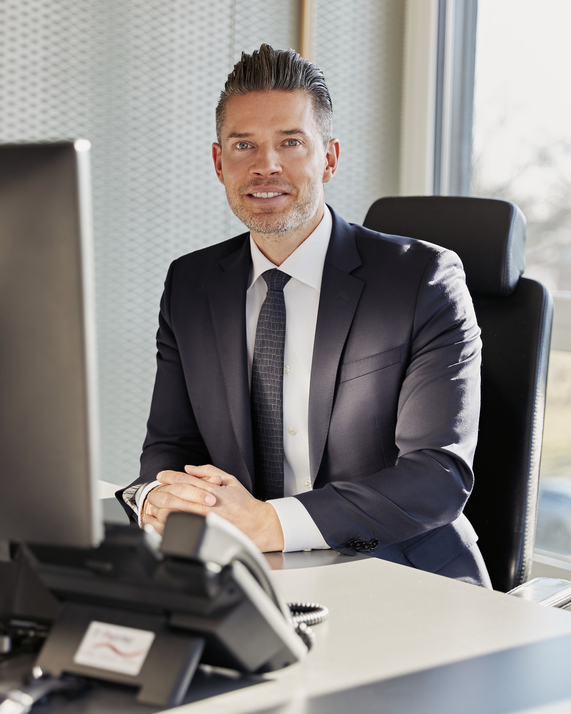 Executive portrait, seated at a desk