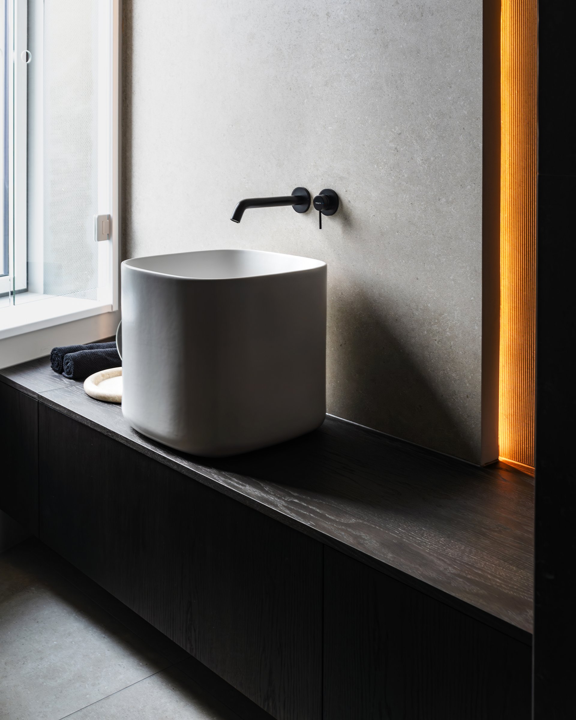 Dark apartment, bathroom sink and wall-mounted tap