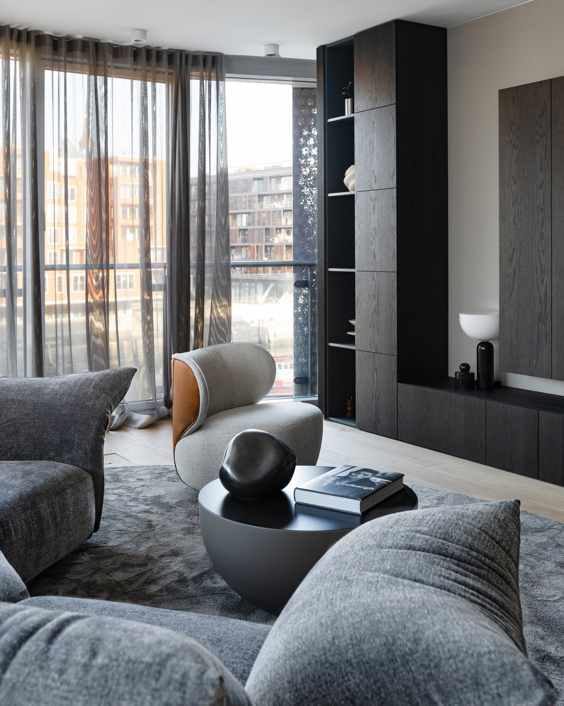 Dark apartment, living room seating and window view