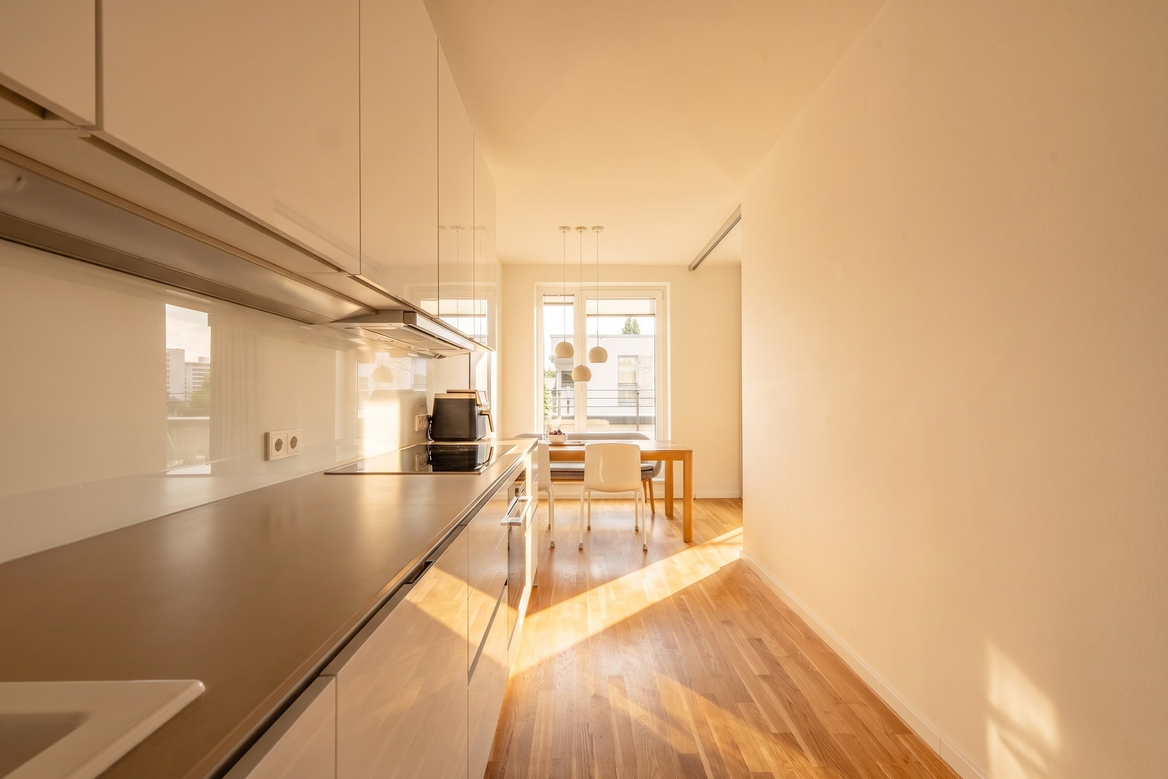 Sunlit apartment, kitchen counter and dining view