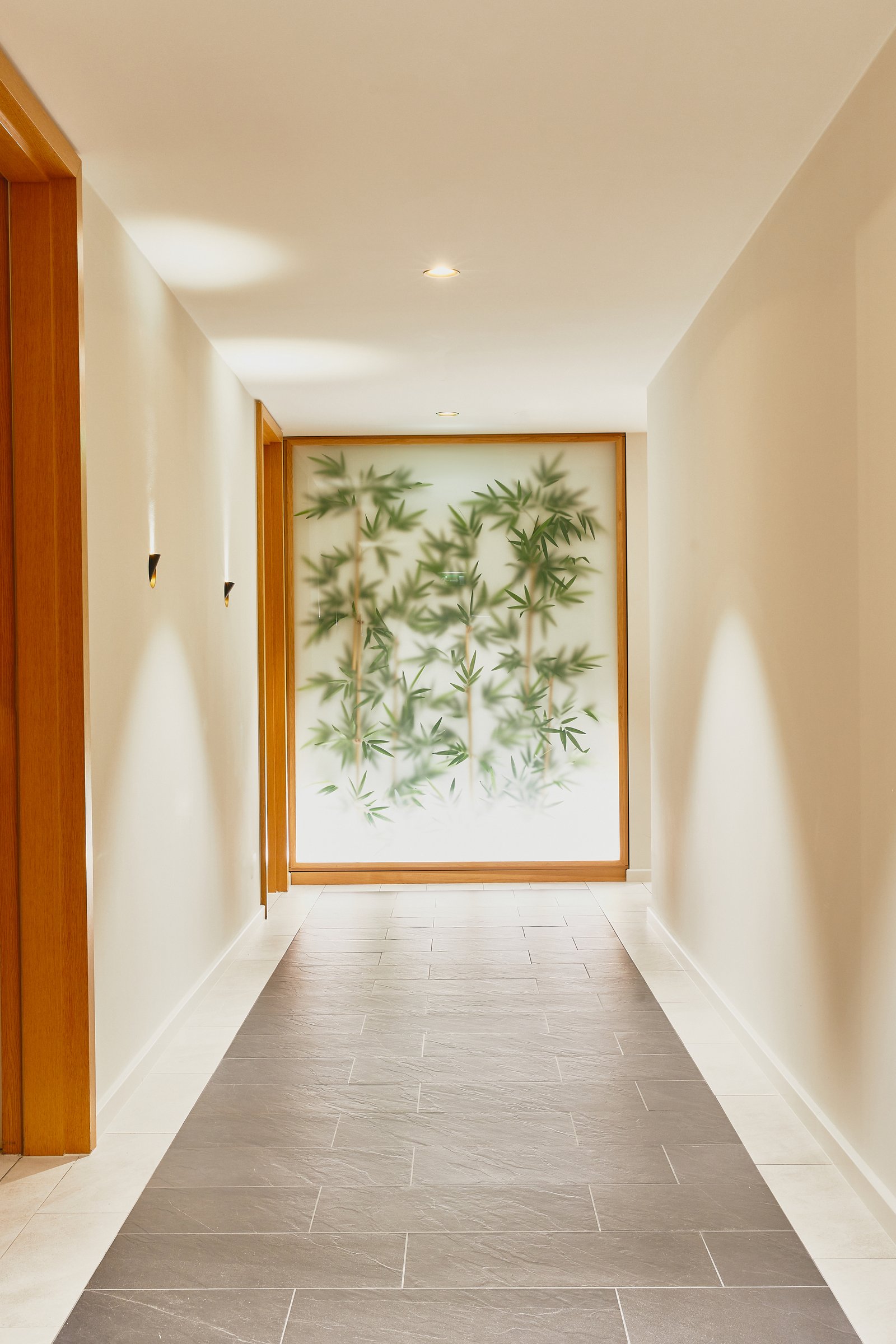 Spa corridor, backlit bamboo-motif glass panel