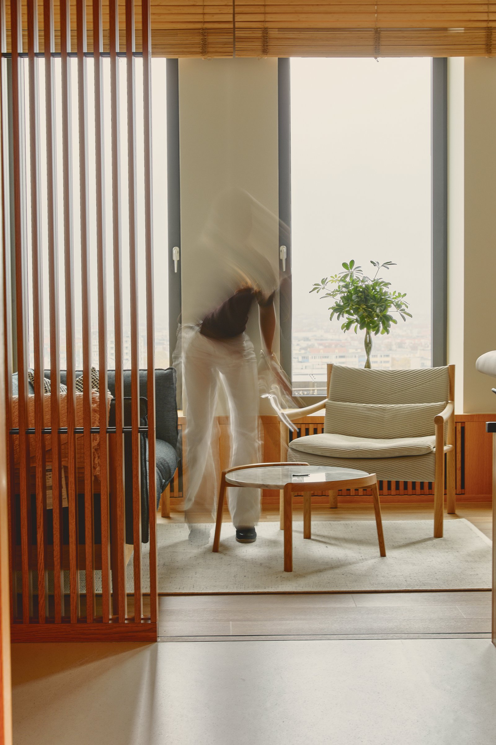 Lounge area, figure in motion, wooden slat divider