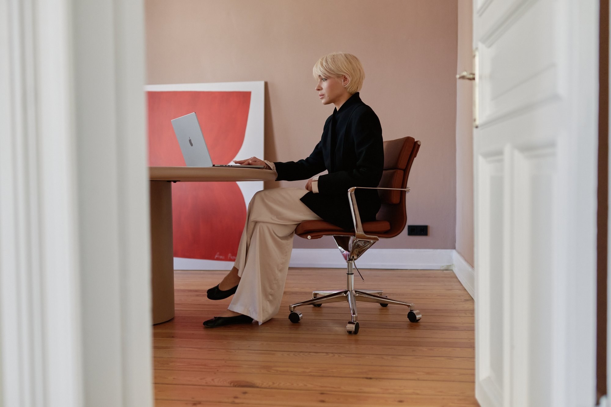 Signature portrait, working at desk, doorway view