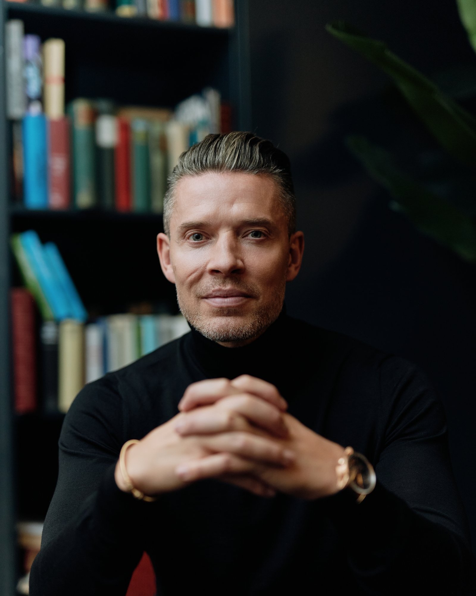 Signature portrait, seated, bookshelf background