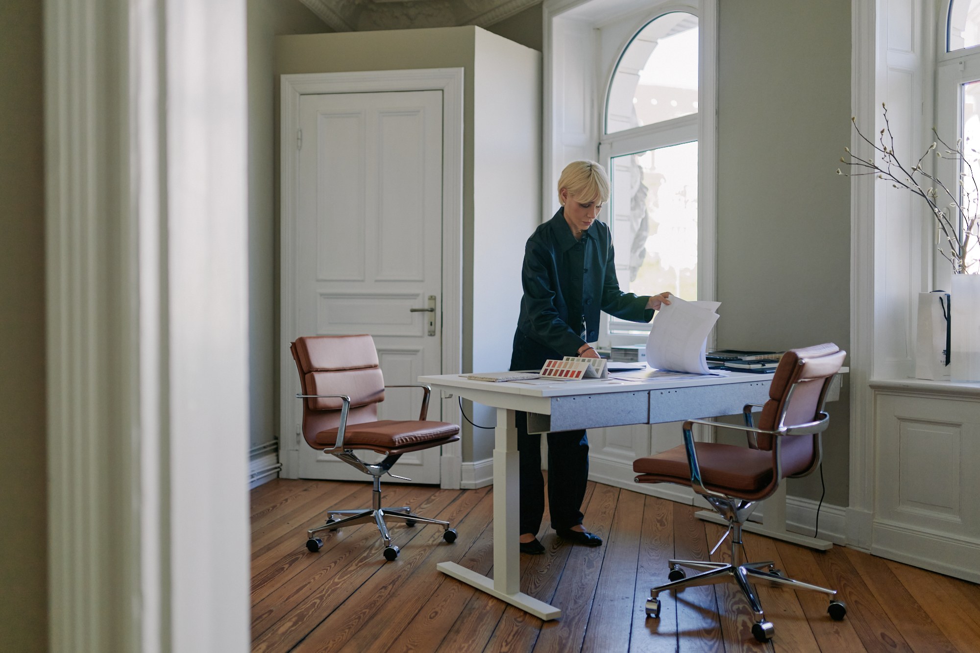 Signature portrait, reviewing plans at the desk