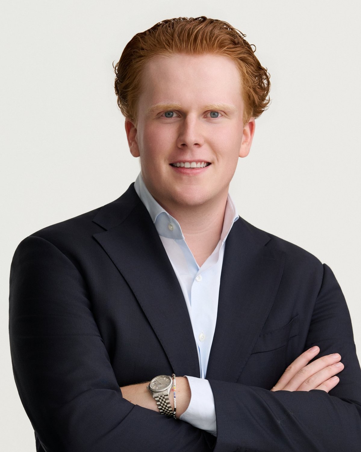 Studio portrait, navy suit, arms crossed