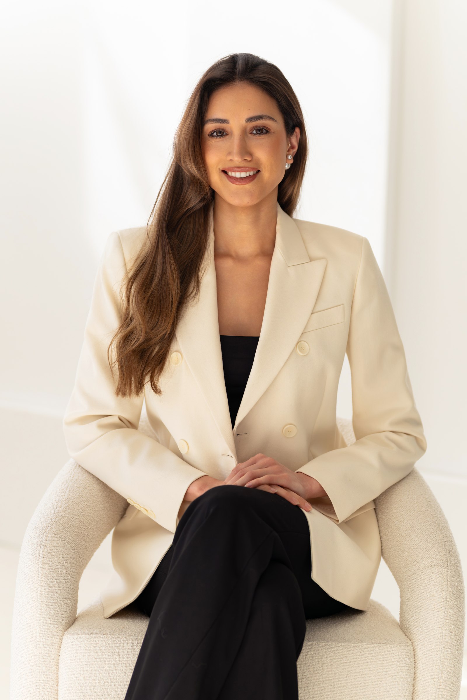 Studio portrait, seated, cream blazer