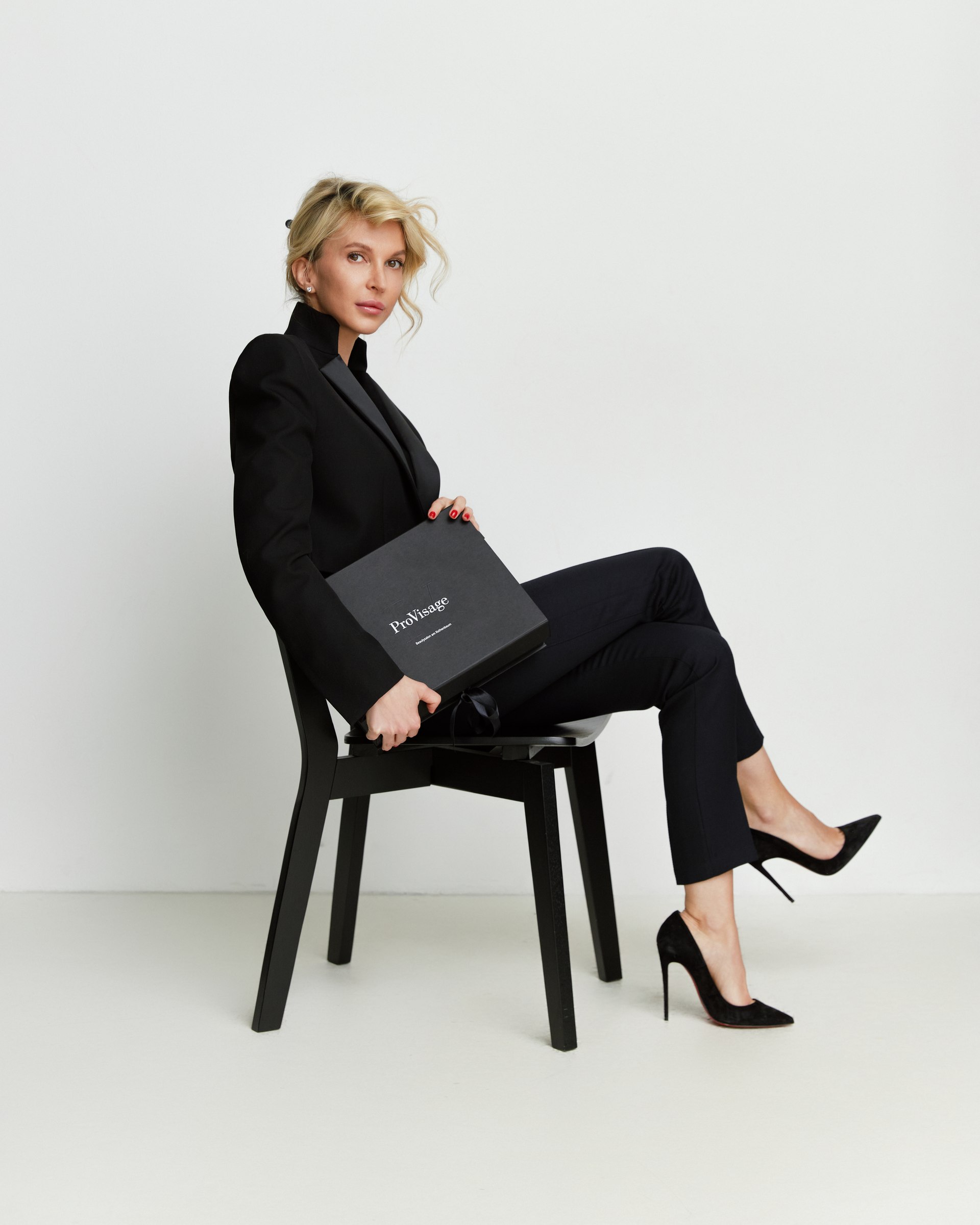 Studio portrait, seated, black suit