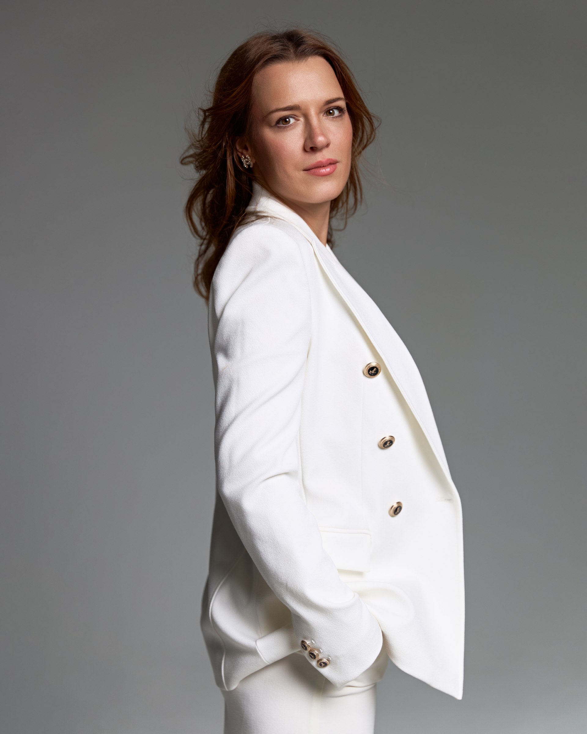 Studio portrait, side profile, white blazer