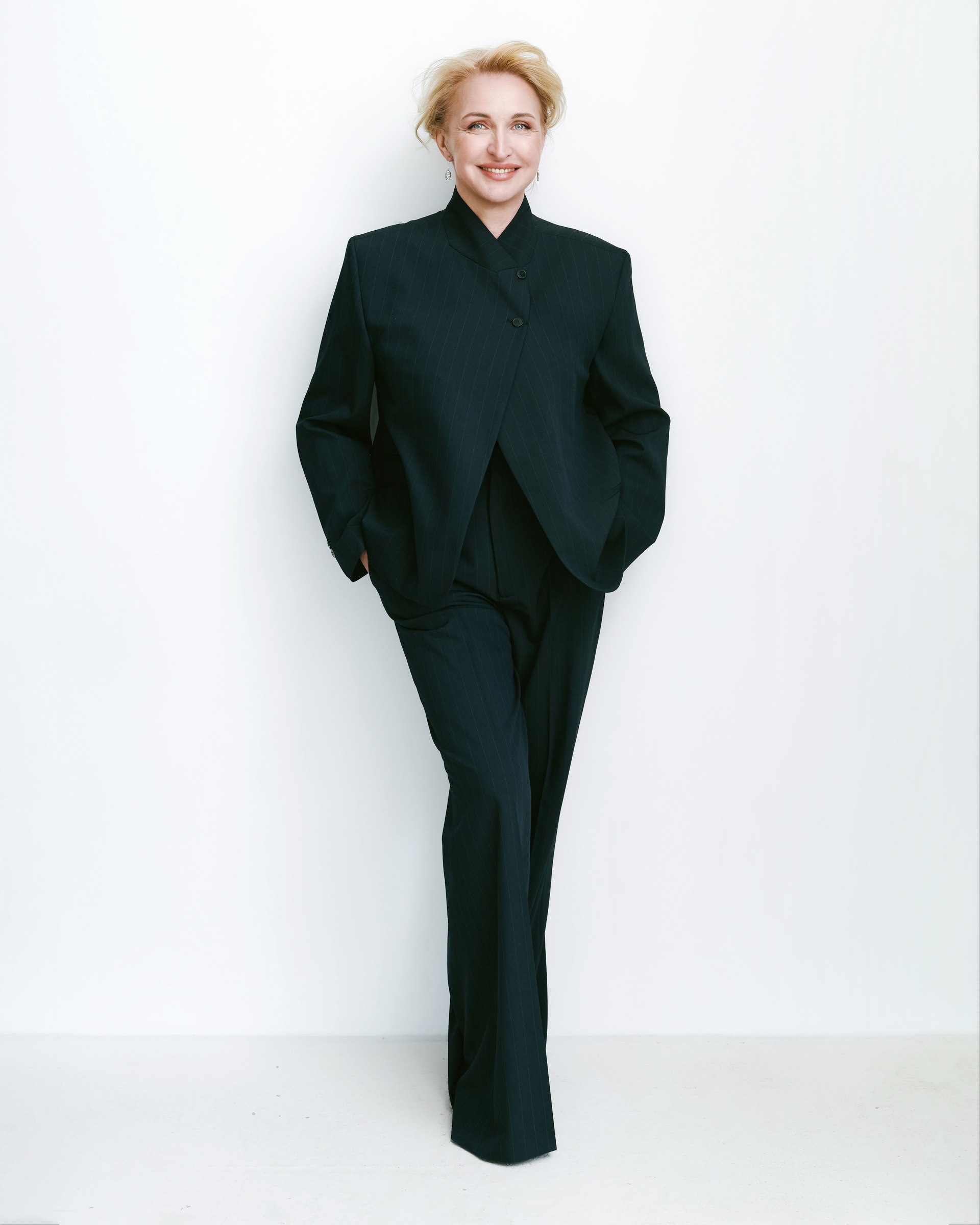 Studio portrait, full length, black suit