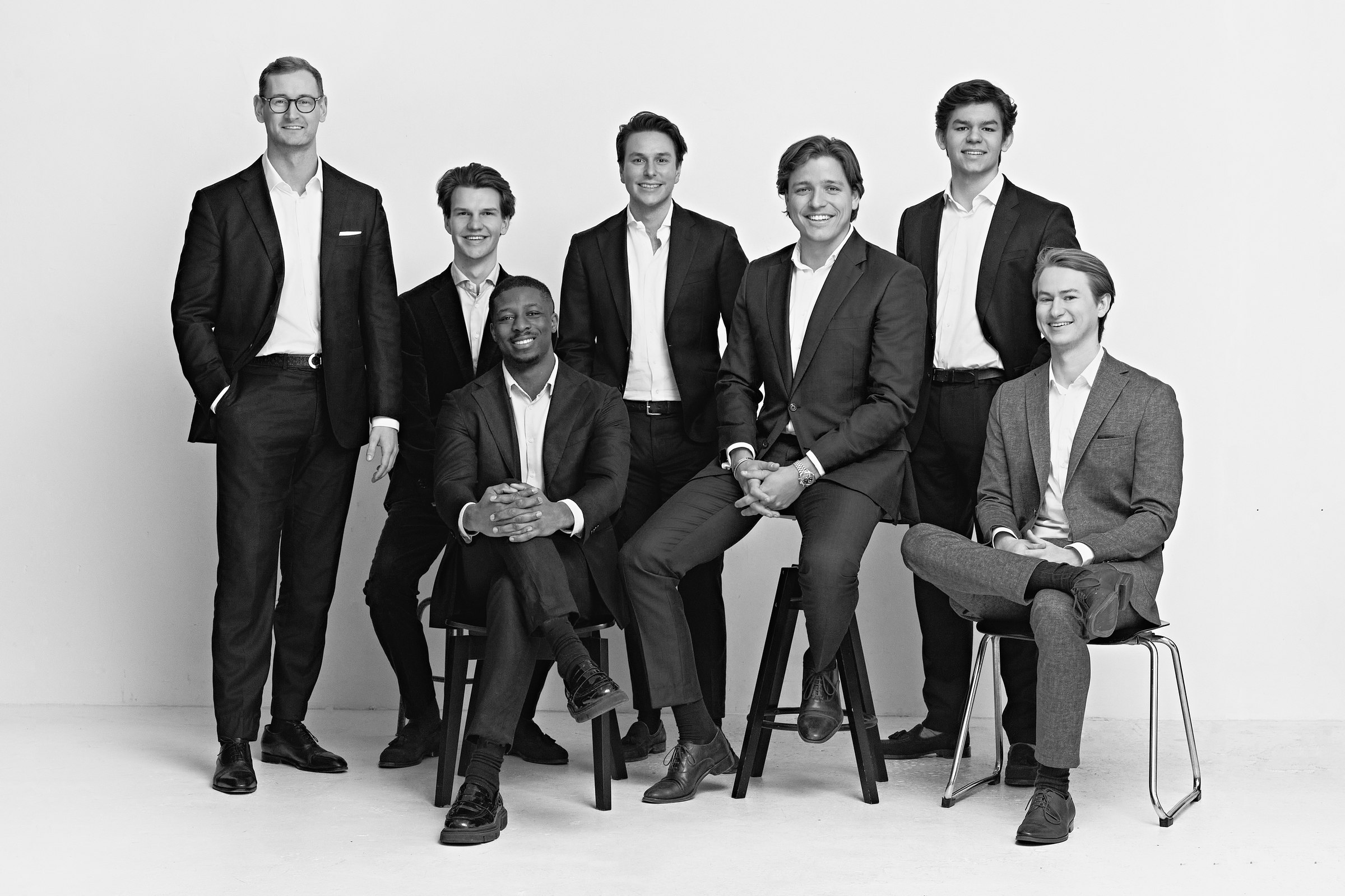 Studio portrait, group of seven men, black and white